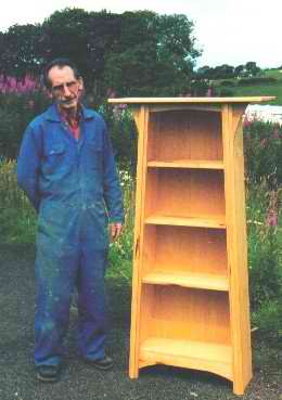 photograph of Stevie Mackenzie and a bookcase